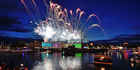 Fireworks exploding over Bristol Harbourside at night.
